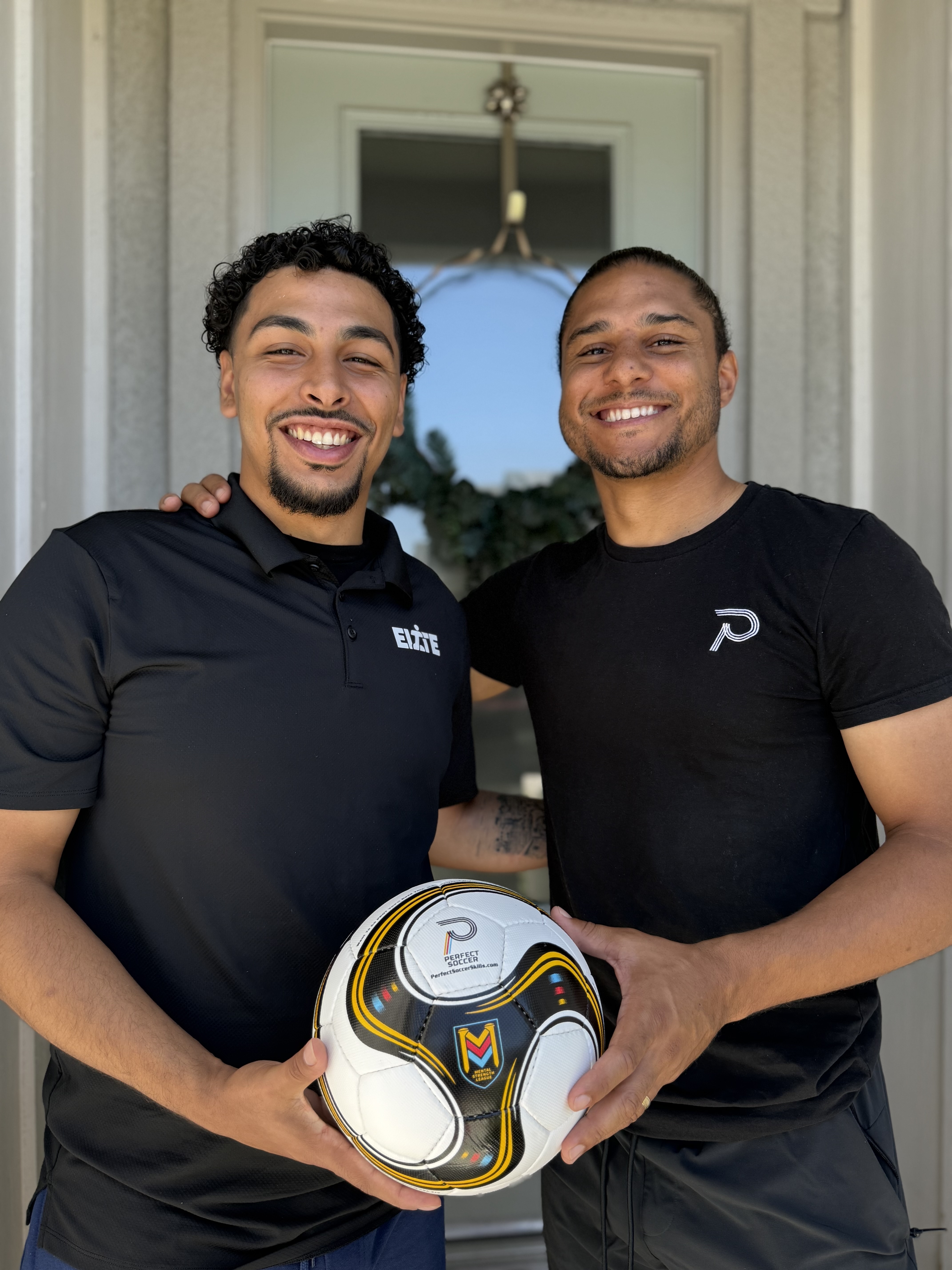 Felipe and Quincy Amarikwa holding a Perfect Soccer ball — Elite Hydration × Perfect Soccer partnership